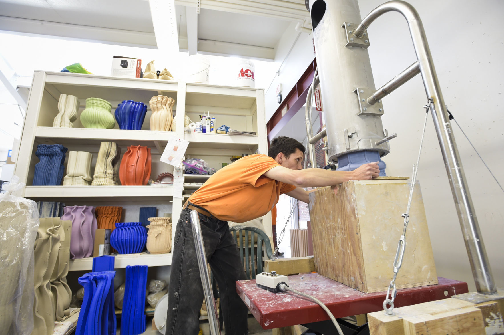 Anton Alvarez works on a piece of art recently in his Archie Bray studio using a clay extruding machine